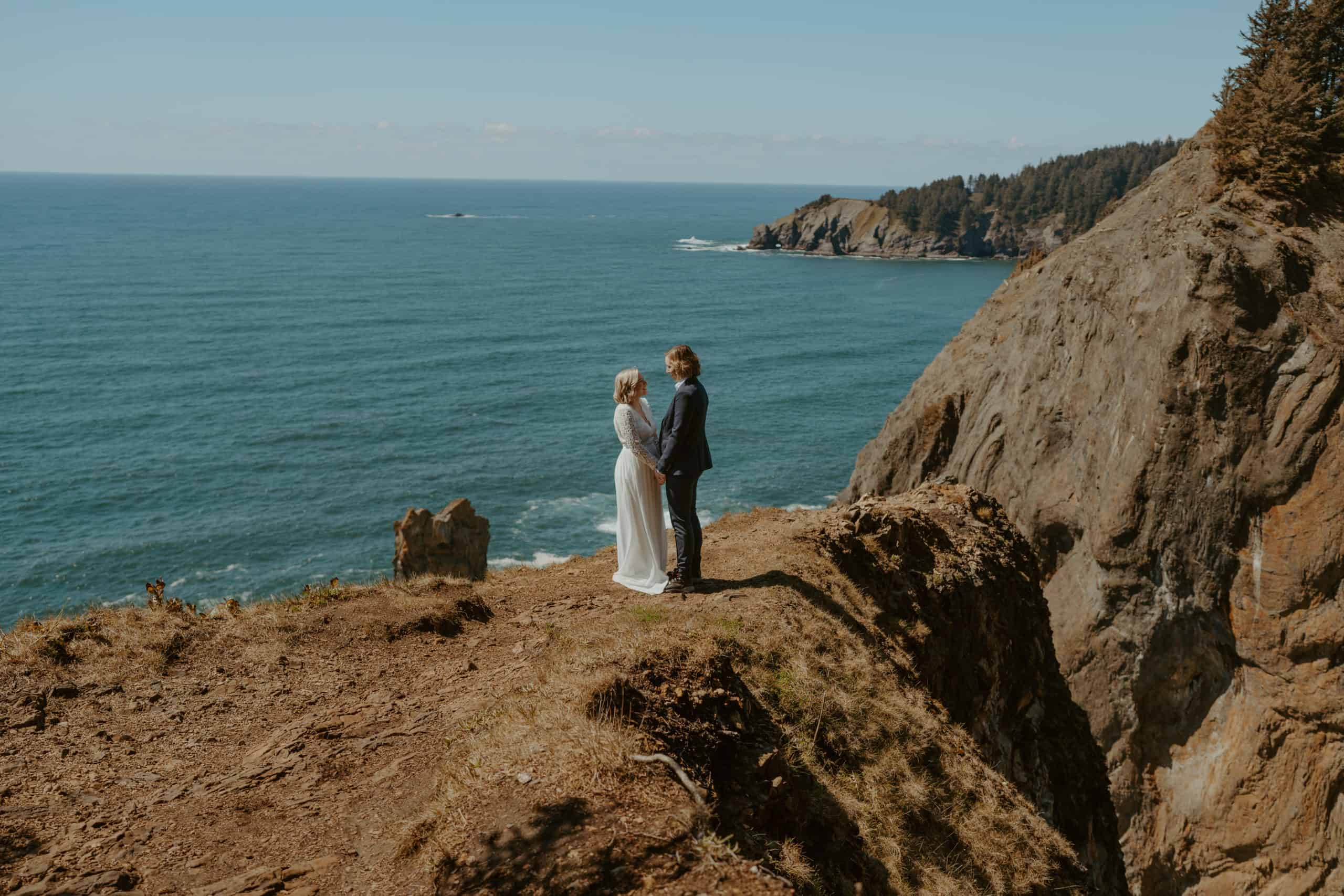 couple reading vows on the cliffside at the oregon coast