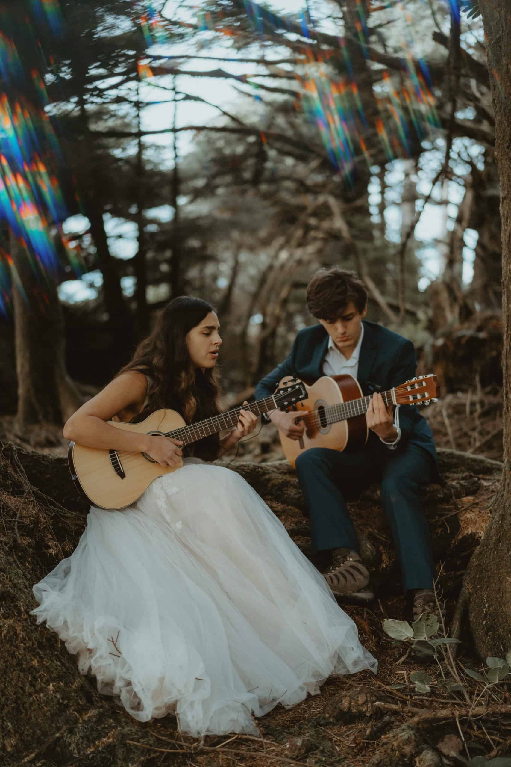 couple playing guitar at elopement