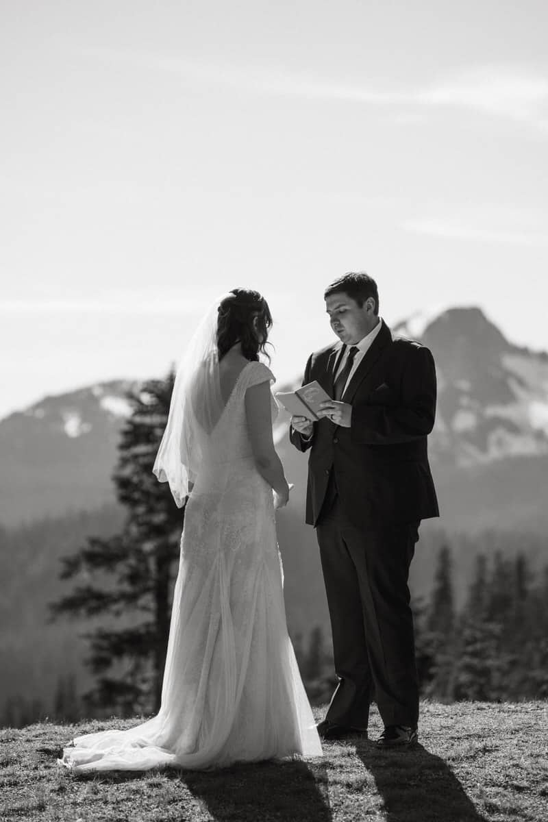 couple reading their vows overlooking the mountains